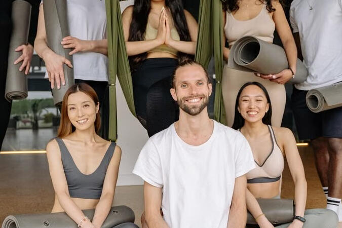 A diverse group enjoying a yoga workshop in a bright studio. Illustrative photograph.